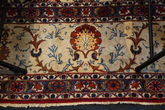 A Kashan ivory ground carpet, 14ft 3in by 10ft 7in.